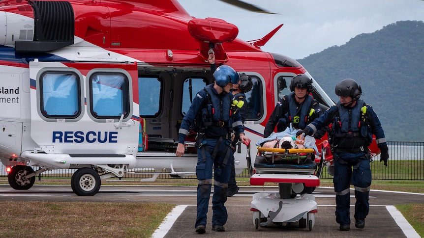 Paramedics transporting injured teen from rescue helicopter