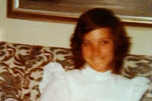 An old photo of Lee Standifer smiling in front of a birthday cake.