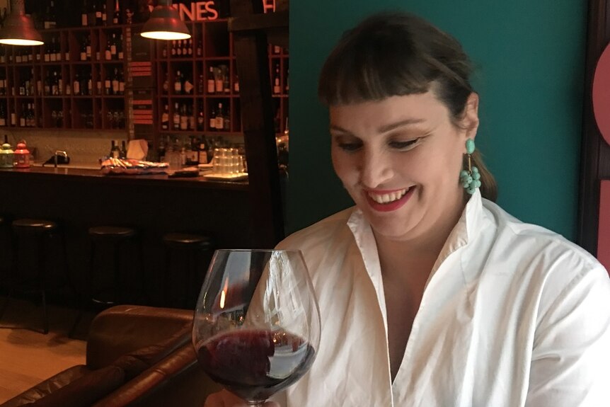 Rebecca Bullen drinks a glass of red wine