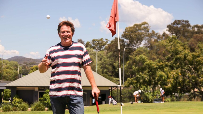 Matt Webber on the golf course, holding a golf club.