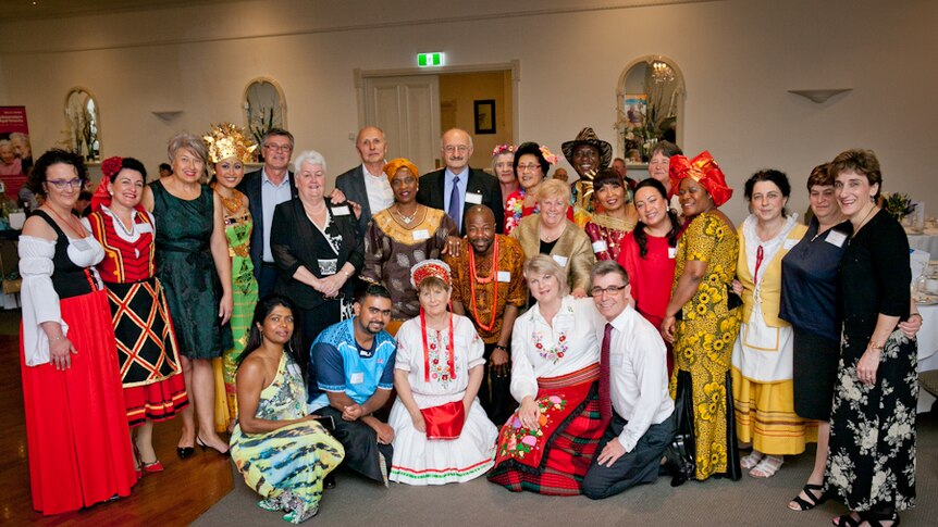 A group of people from different cultural backgrounds wearing traditional outfits.