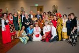 A group of people from different cultural backgrounds wearing traditional outfits.