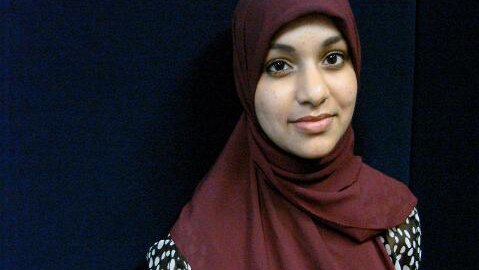 Teenage girl in hijab smiles