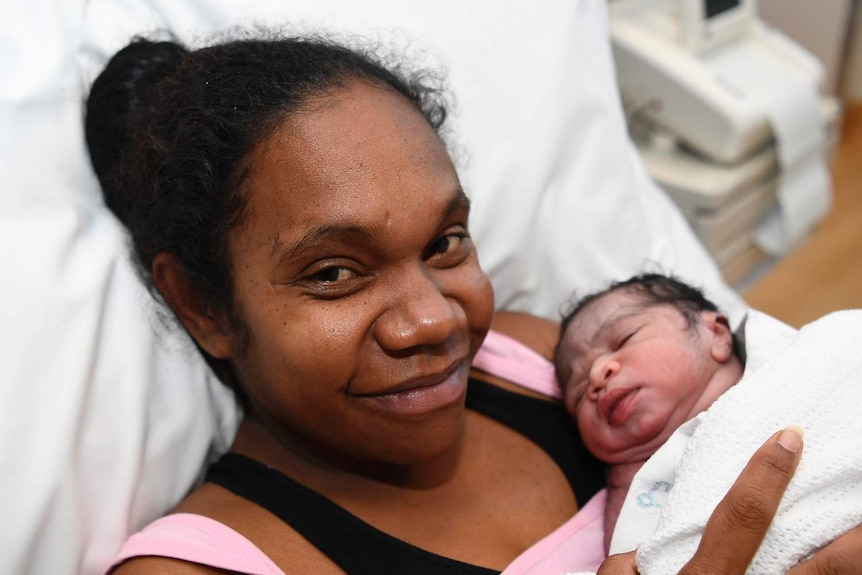 Samantha Kerr lies in a hospital bed with her new born baby boy Cordy Kerr-Kennedy in Townsville