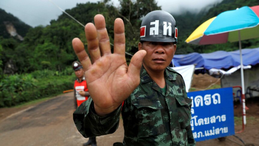 Thai soldier blocks road to cave rescue