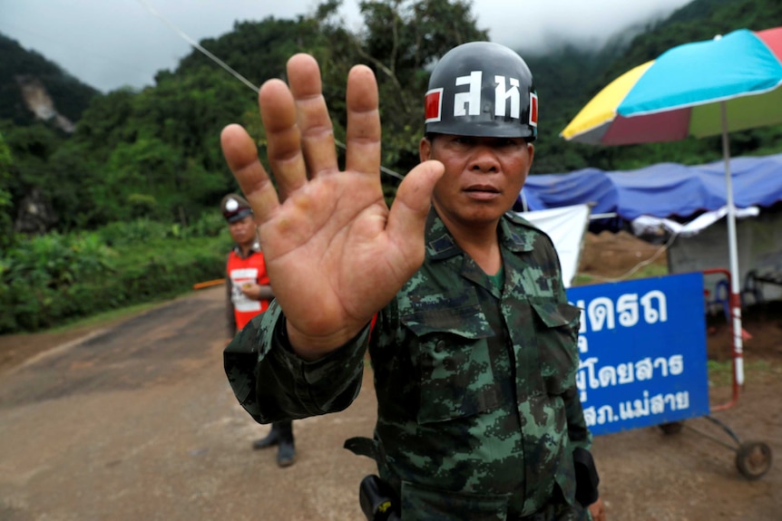 Thai soldier blocks road to cave rescue