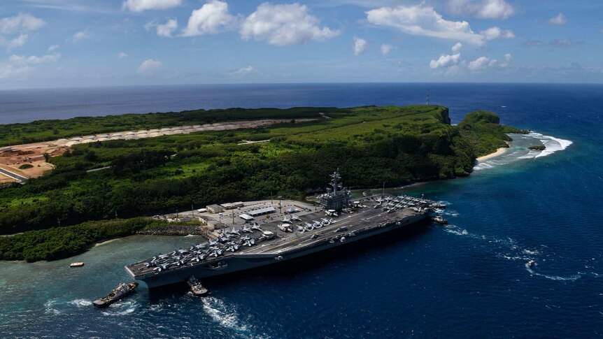 The aircraft carrier USS Theodore Roosevelt departs Naval Base Guam.