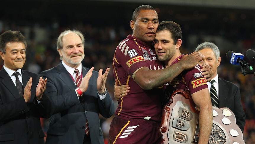 The Maroons' Petero Civoneciva and Cameron Smith embrace while holding the Origin Shield.