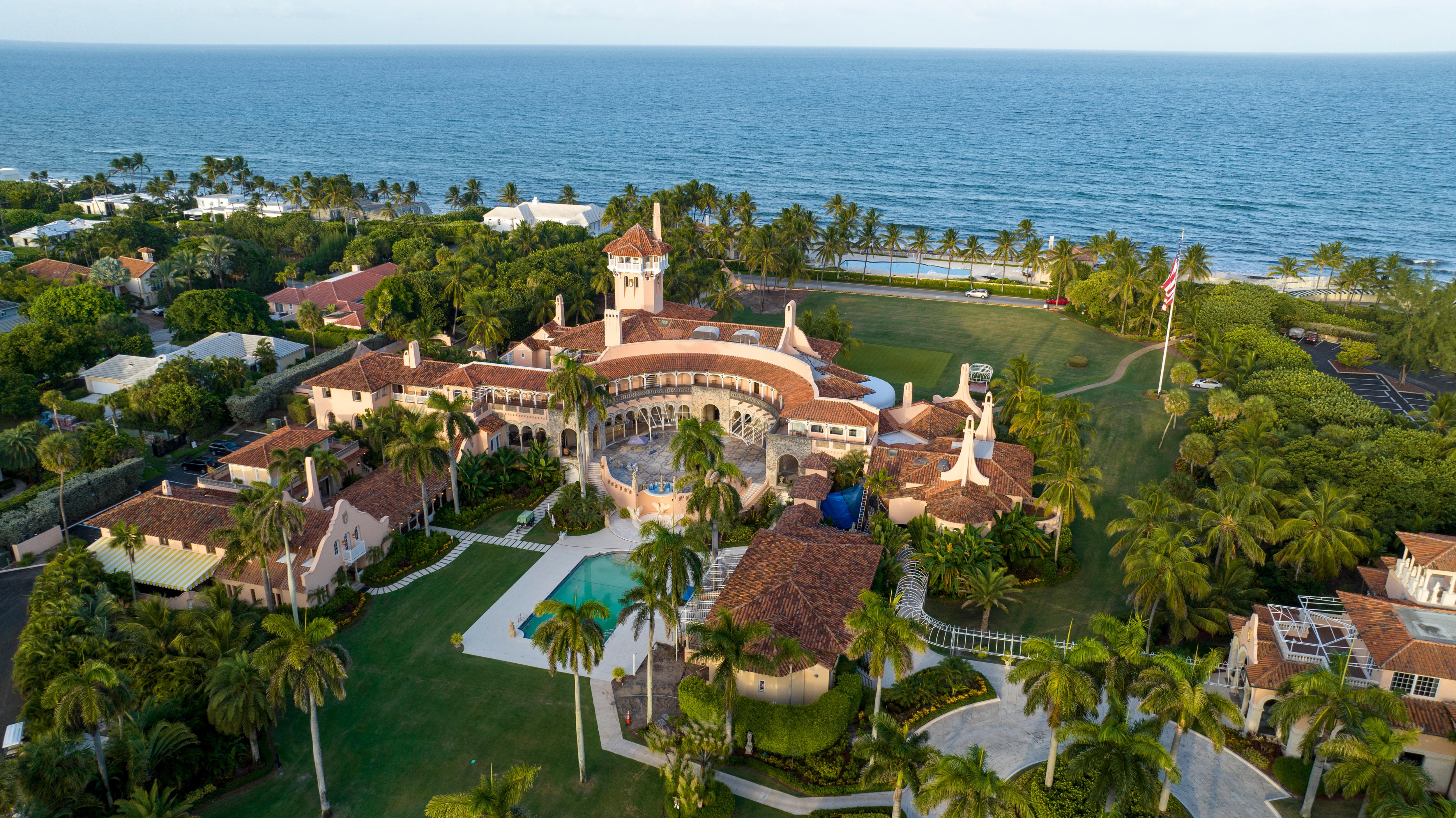 A drone shot of a luxury gold club and hotel at the edge of the ocean