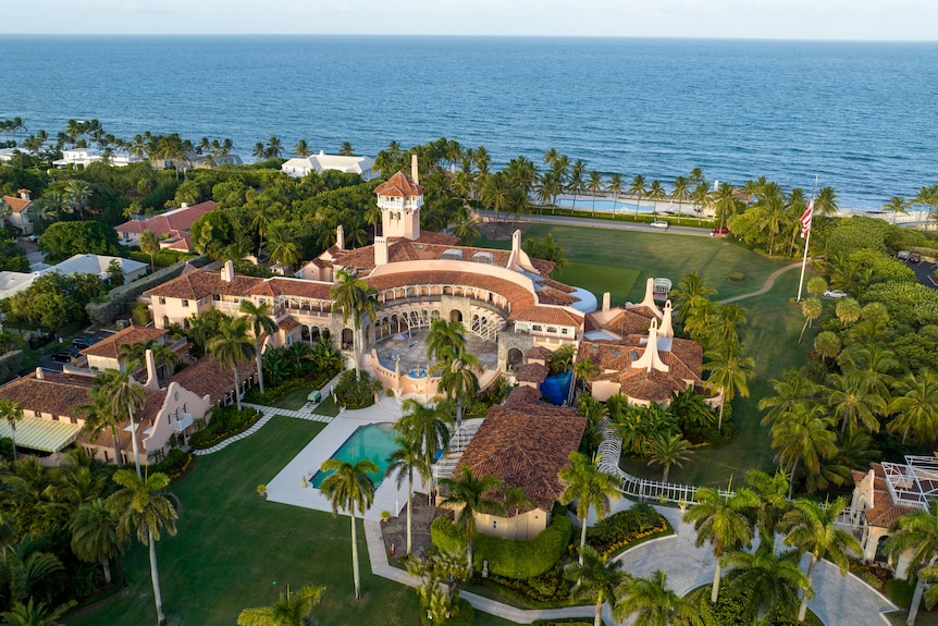 A drone shot of a luxury gold club and hotel at the edge of the ocean