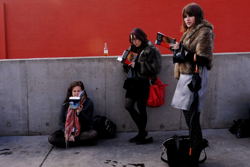 Harry Potter fans read their copy of Harry Potter and the Deathly Hallows