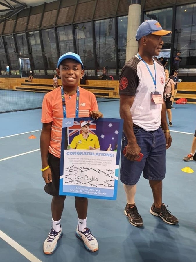 Sele, 10 year old boy holding poster at 2020 Australian open