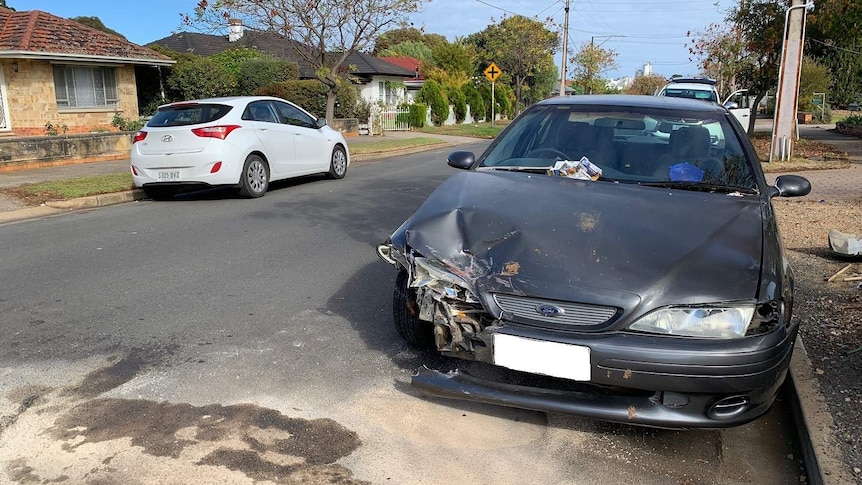 A car with damage to its front bumper and headlight