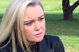 Former Liberal federal election candidate Jessica Whelan frowns as she talks to a reporter
