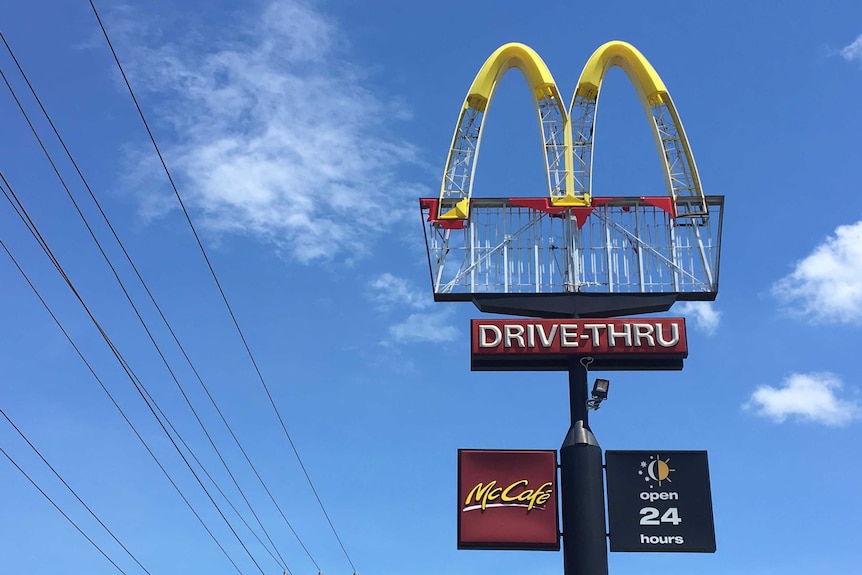 A battered McDonald's sign missing panels.