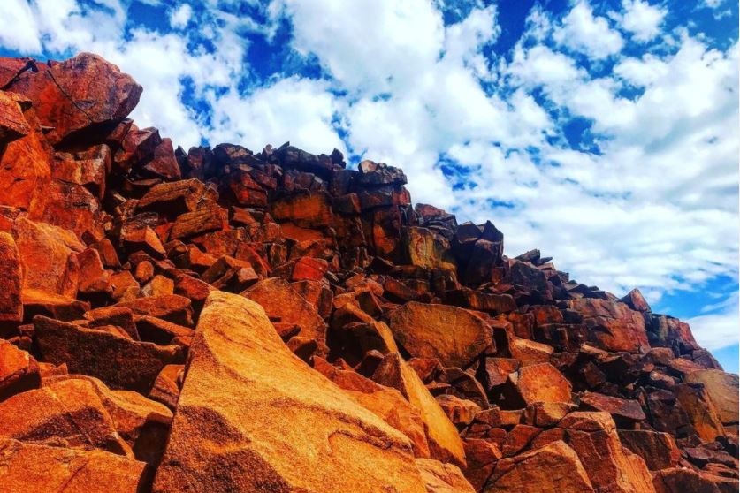 rock formation with blue sky in the background.