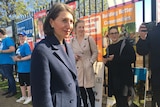 Gladys Berejiklian stands in front of campaign posters at the Wagga Wagga byelection