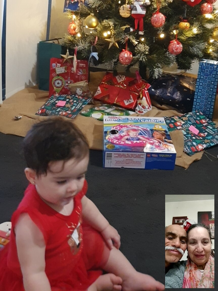 Valeria Greenfield's daughter in front of a Christmas tree, with her grandparents on video chat in the corner of the screen.