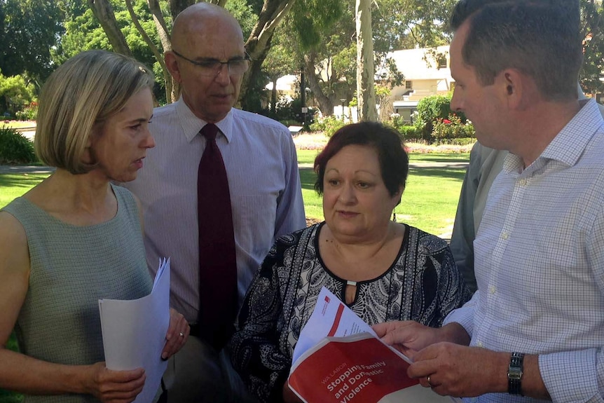 Angela Hartwig surrounded by Labor members.