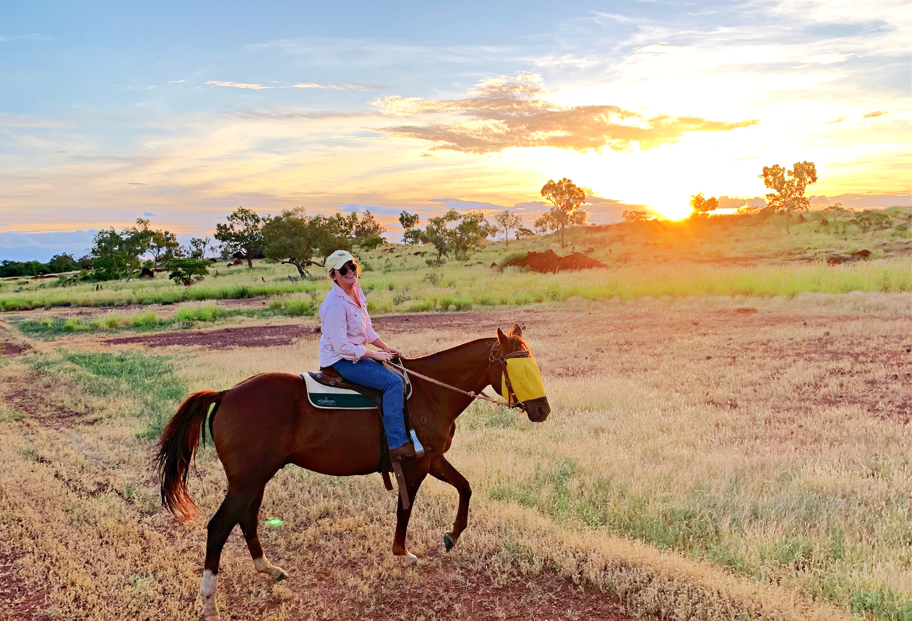 A woman on a horse in the outback