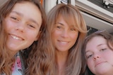 Three females smiling at camera