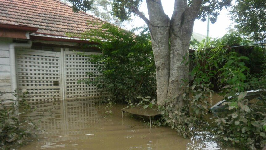 A home awash in rising floodwaters