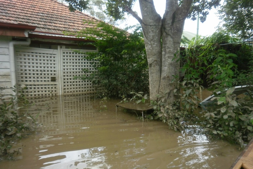 A home awash in rising floodwaters