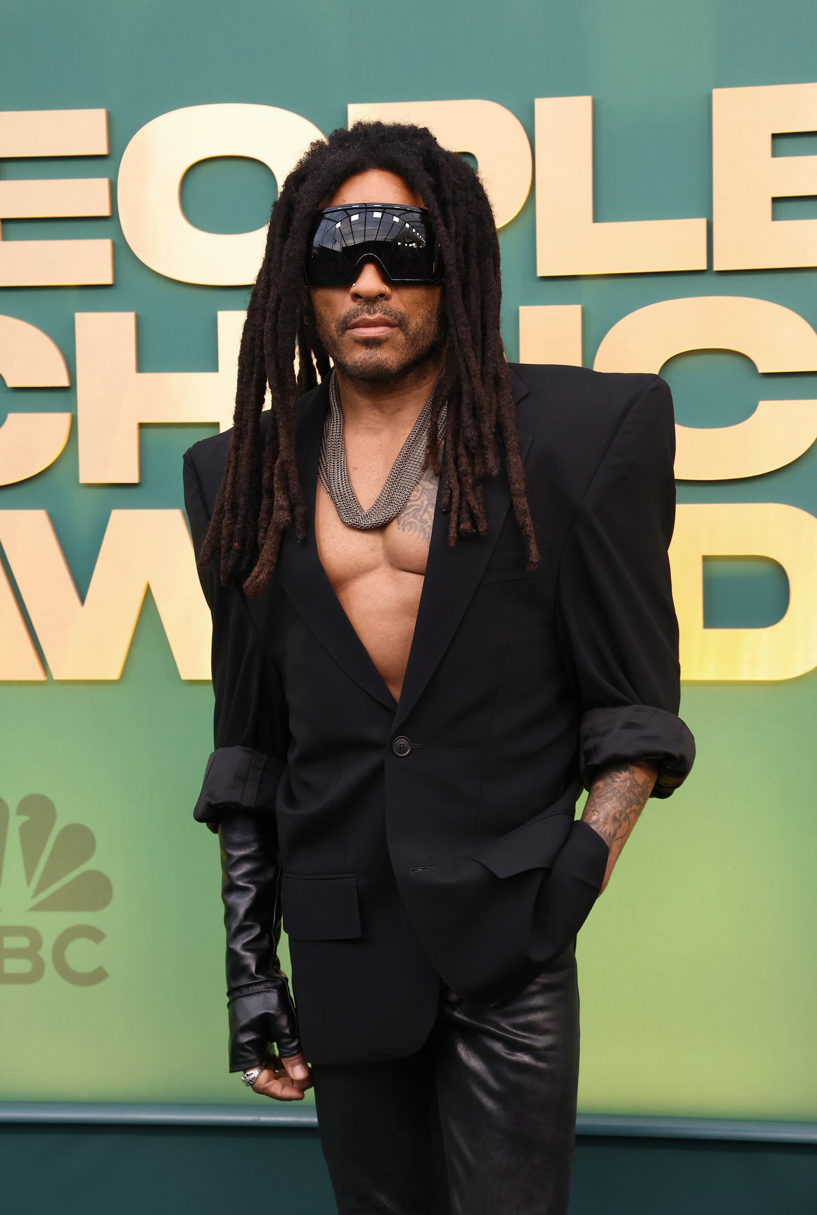 Lenny Kravitz wearing a black suit with a big pair of sunnies on