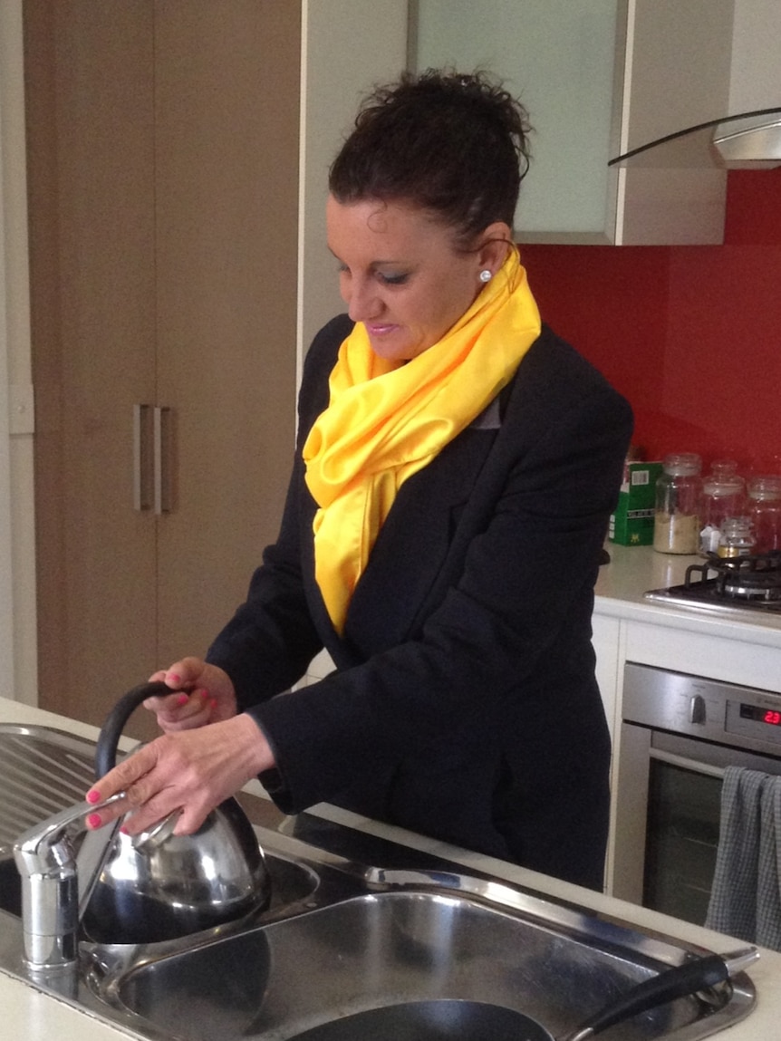 Jacquie Lambie, Palmer United Party Senate hopeful, fills a kettle in her kitchen.