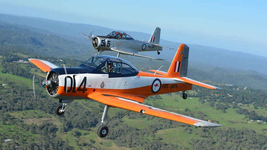 Two 1950s aircraft flying in formation