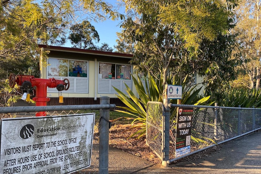 Chatswood Hills State School front gate and building surrounded by trees.