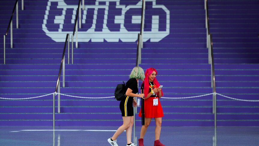 attendees walk past purple stairs painted with the Twitch logo at E3 Los Angeles