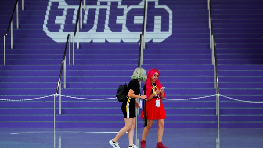 attendees walk past purple stairs painted with the Twitch logo at E3 Los Angeles