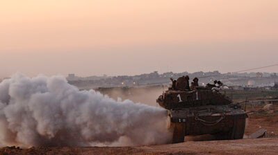 Cease-fire: an Israeli army tank rolls out of the Gaza Strip near kibbutz Mefalsim.