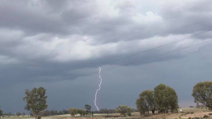 lightning bolt over rural plains with storm clouds
