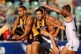 Shaun Burgoyne of the Hawks handballs against GWS