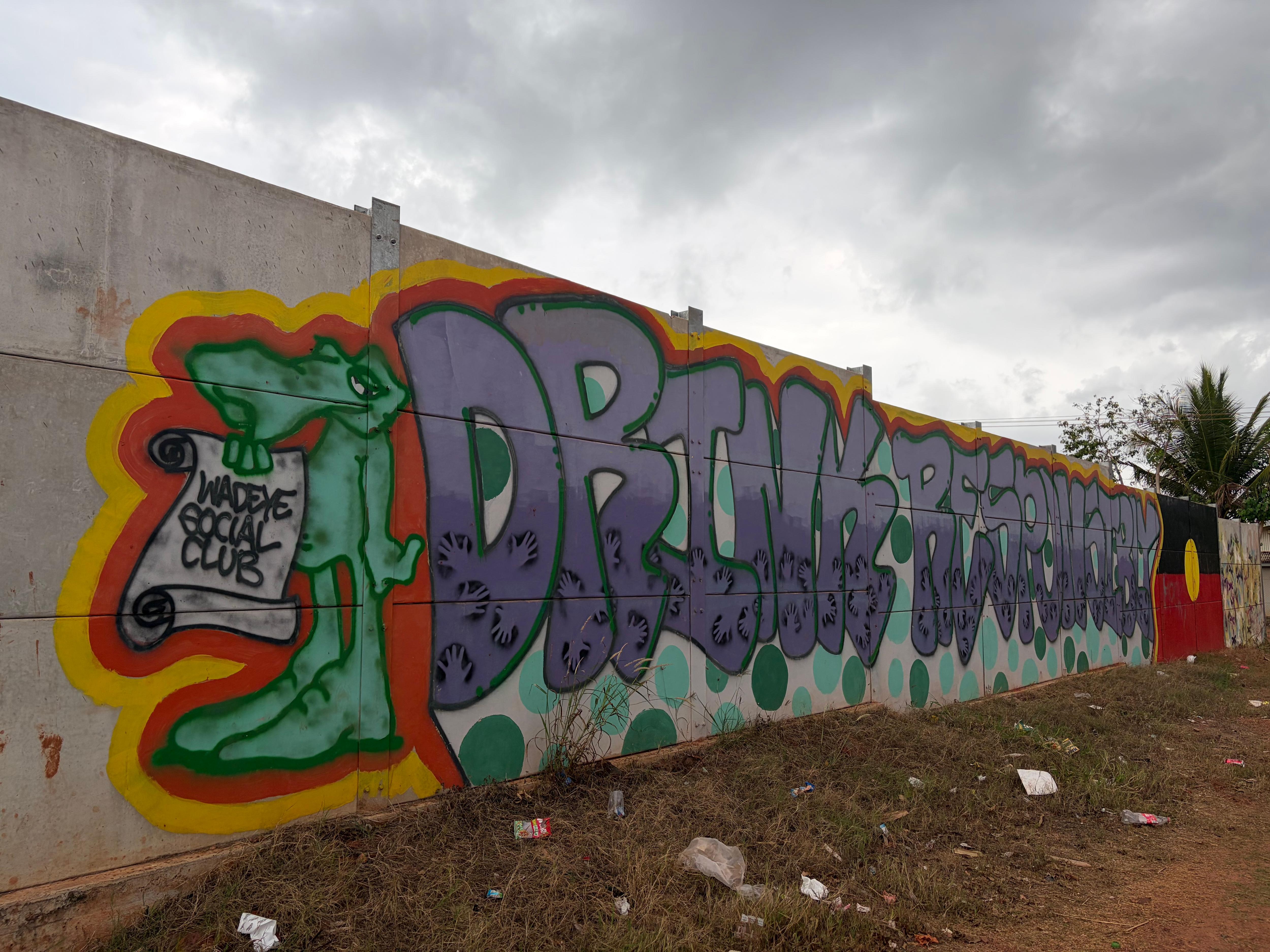 Graffiti on wall of Wadeye social club says "drink responsibly"