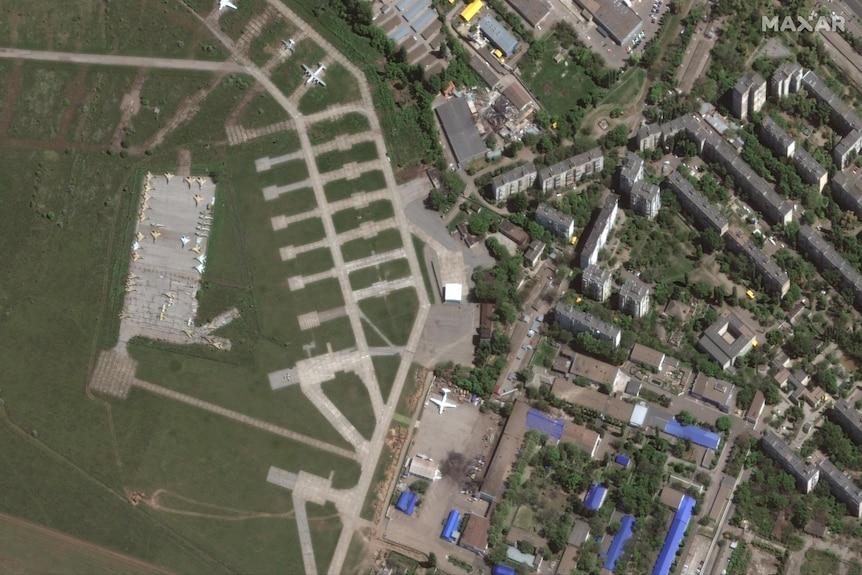 Damage to a building near a plane is seen at Odessa Airport. 