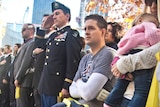 U.S. Air Force Senior Airman Brian Kolfage, center, sits in a wheelchair next to his wife Ashley.