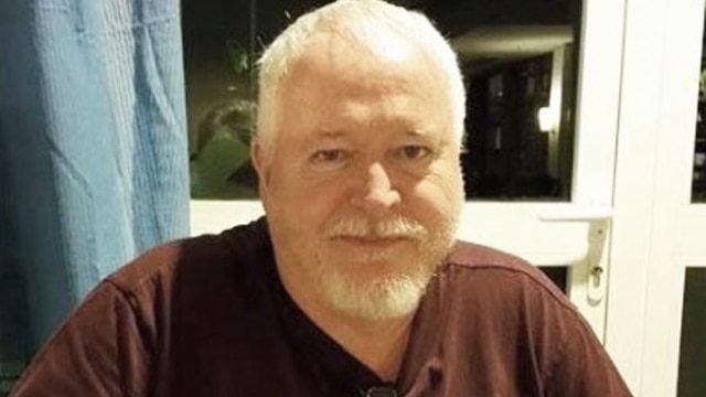 Image of Bruce McArthur, he is an older man with white hair and a beard, he is wearing a brown t-shirt.