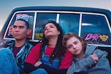 Chloë Grace Moretz, Forrest Goodluck and Sasha Lane sitting in back of pick-up truck in film The Miseducation of Cameron Post.