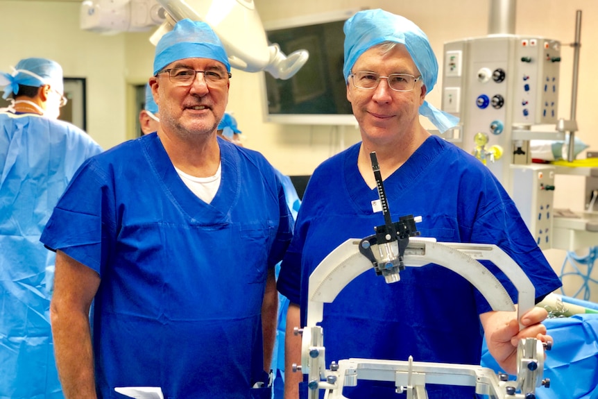Peter Silburn and Terry Coyne in the operating theatre.