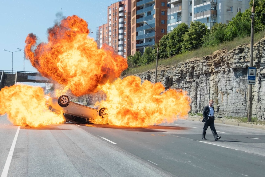 A man walks away from an exploding car in the movie Tenet