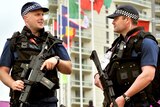Armed police patrol the Athletes' Village at the Olympic Park site in Stratford, east London.
