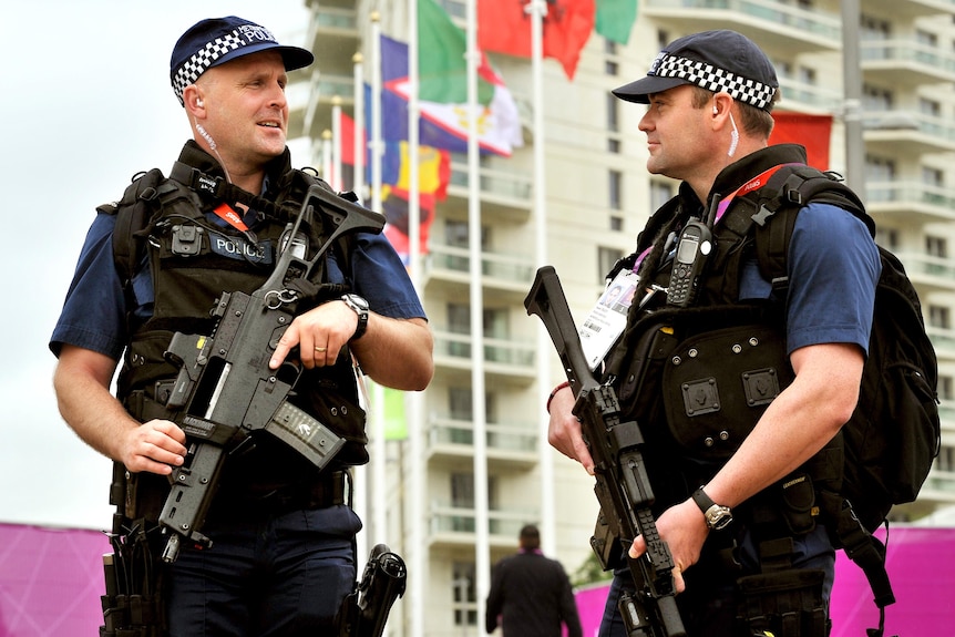 Armed police patrol the Athletes' Village at the Olympic Park site in Stratford, east London.
