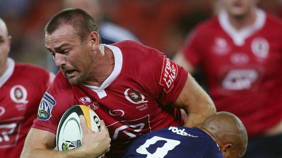 Chris Latham of the Reds is tackled during their Super 14 match against the Stormers