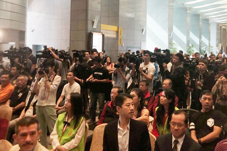 A packed hall of Taiwanese media and officials wait for the Australian Firefighters to arrive for a press event.