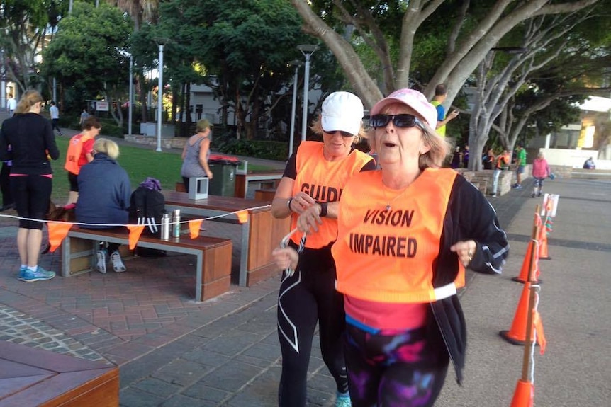 Barbara Clarke and Wendy Compton cross the finish line.