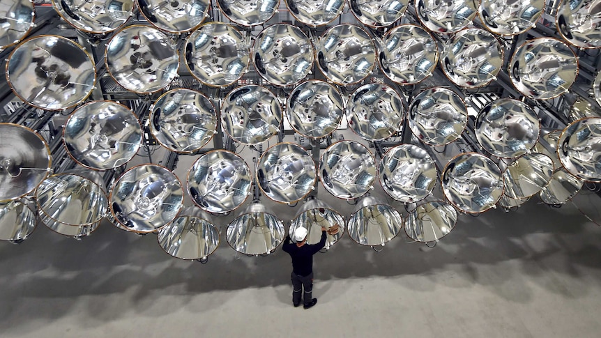 Engineer Volkmar Dohmen stands in front of xenon short-arc lamps.