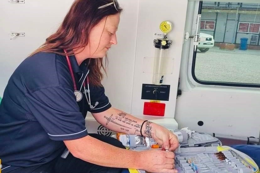 A paramedic inside an ambulance, with medical equipment 